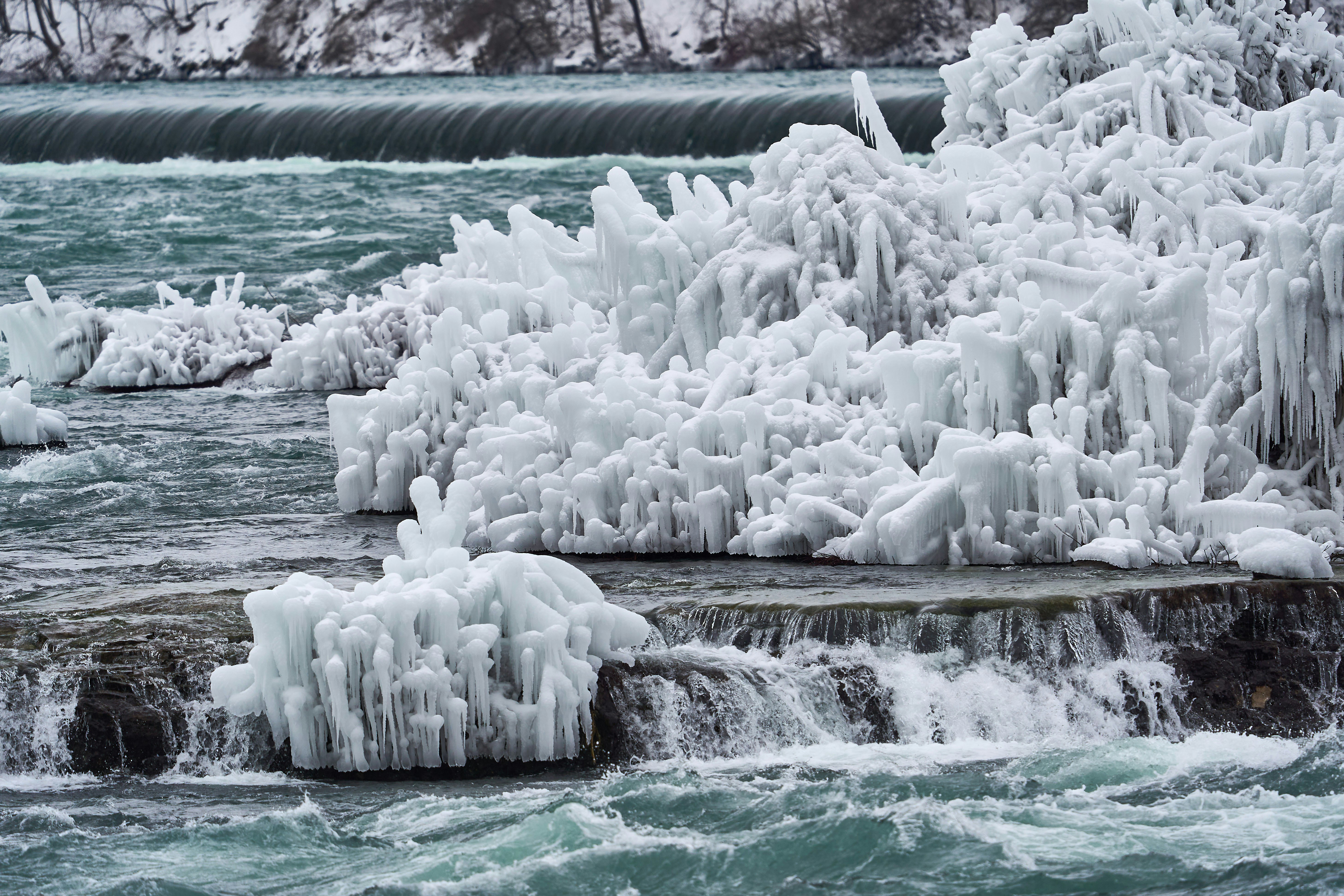 white ice on body of water during daytime